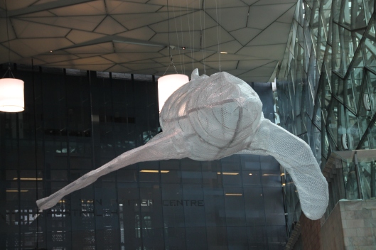 A whale made from bubble wrap and suspended at Federation Square. 